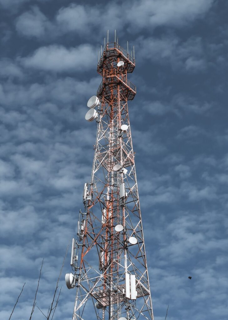 Tall communication tower against a cloudy sky representing network.